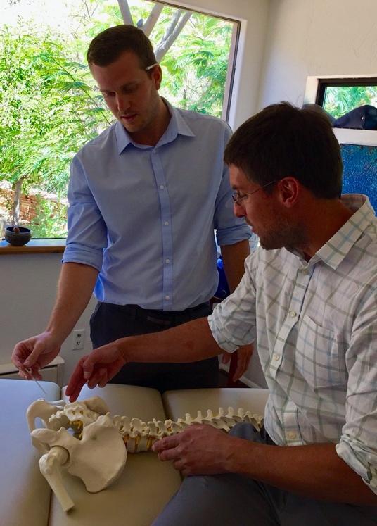 Nate and Rob looking at a pelvic skeleton model