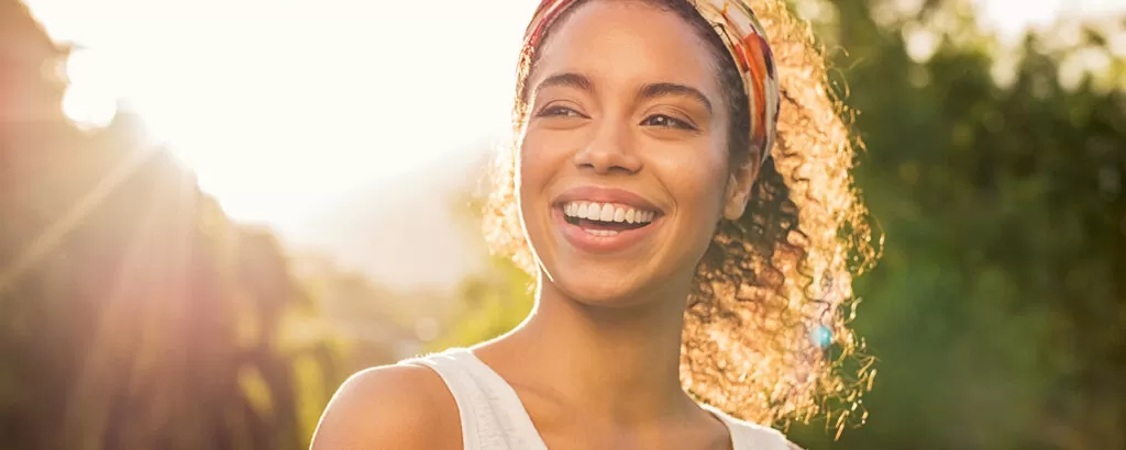 woman smiling at sunset